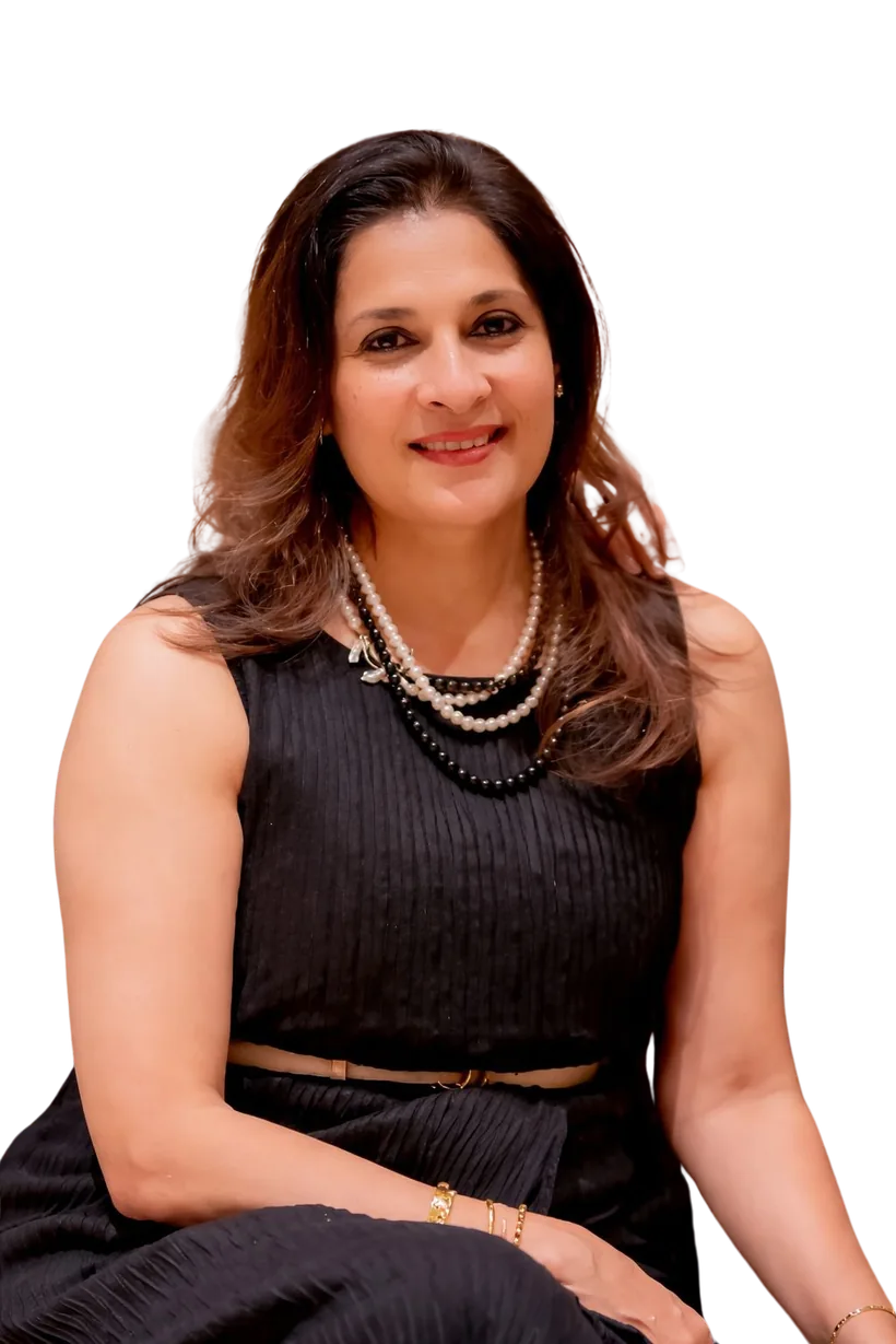 Sangeeta Krisna, smiling, in a black dress and pearls