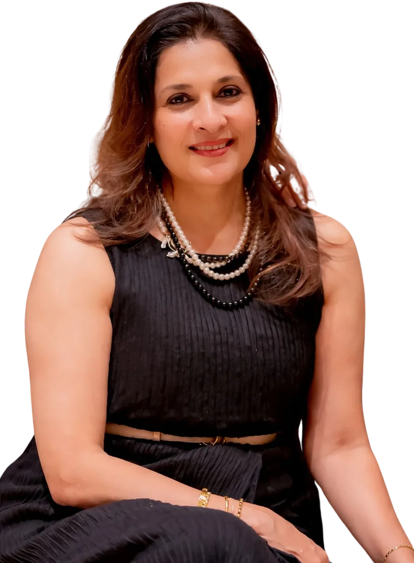 Sangeeta Krisna, seated, in a black dress and pearls
